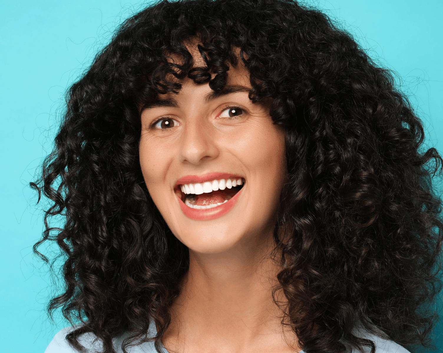 Smiling woman with porcelain veneers at Lee Dental Care